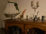 a wooden cabinet with a lamp on top of it