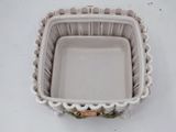 a small square dish on a white table