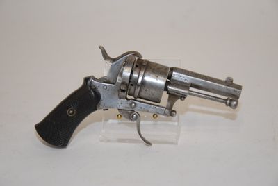 a gun that is sitting on top of a clear block