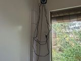 a picture of a room with a window and wires on the wall