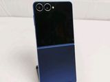 a close up of a cell phone on a stand on a white surface