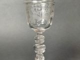 a glass cup with a bird on top of it
