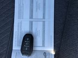 a car key and a piece of paper on the seat of a car