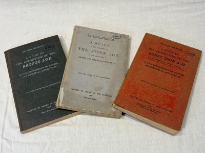 three books sitting on top of a white table next to each other