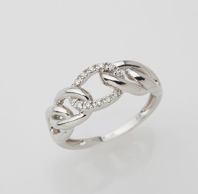 a white gold ring with diamonds set in the middle