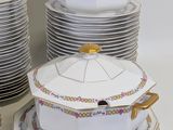 a lot of plates and bowls on the table