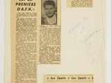 an old newspaper with a picture of a man in a suit and tie