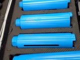several blue cylinders are lined up in a case on a table