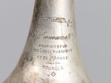 a silver bell that is sitting on a table