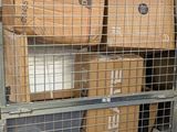 many boxes stacked on top of each other behind a wire fence