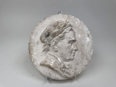 an image of a white marble medallion with a man ' s face