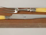 two knives and a knife holder on a wooden board