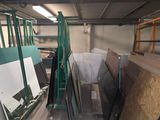 many pieces of wood in a room with a lot of windows