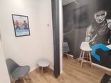 a photo of a room with a wall mural and a chair