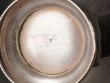 a close up of a metal bowl on a stove