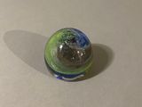 a glass ball with a green and blue design on it