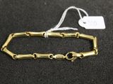 a close up of a gold bracelet on a black surface