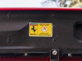 a ferrari badge on the front of a red car