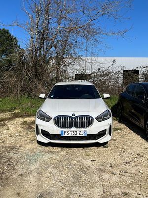 two cars parked next to each other on a dirt road