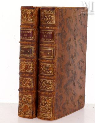an old pair of books sitting on top of a white table