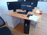 a desk with two computer monitors and a keyboard on it