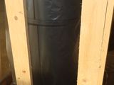a black plastic bag sitting on top of a wooden table