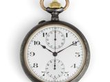 a close up of a pocket watch on a white background