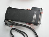 a cell phone sitting on top of a table next to a camera