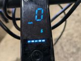 a digital clock on the handlebar of a bike