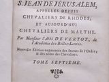 an old book with writing on it sitting on a table