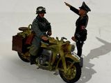 two figurines of two men riding on a motorcycle