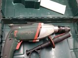 a drill in a green box with a tool in it