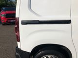 a white van parked in a parking lot next to other cars