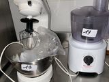 a blender and a mixer sitting on a kitchen counter