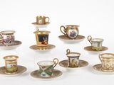 many cups and saucers that are sitting on the table