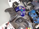 a lot of different video game controllers on the table
