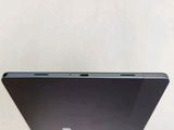 the back of a laptop computer sitting on top of a white table