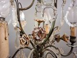 a chandelier that has a bunch of flowers on it