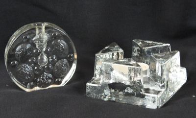 two pieces of glass sitting on a black surface