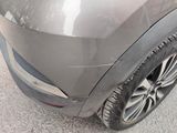 a close up of a car ' s front bumper with a denting on it