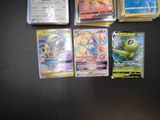 a lot of pokemon cards sitting on a table