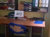 a desk with a laptop and a chair in a room