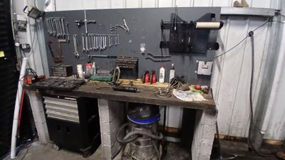 a workbench in a garage with tools on it