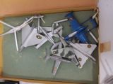 a lot of toy airplanes in a box on the table