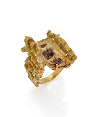 un gros plan d'une bague en or sertie d'une pierre