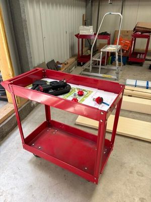 a red work cart in the middle of a room