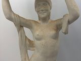 a statue of a woman holding a tray over her head