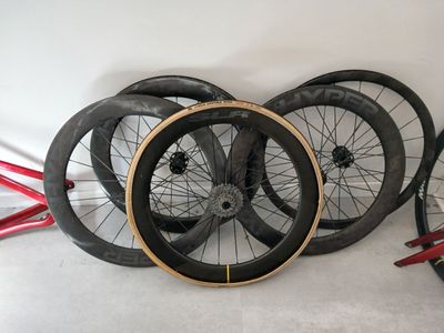 three different types of bicycle wheels sitting on the floor