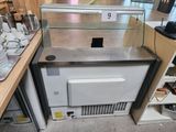 a small refrigerator with a glass case on top of it