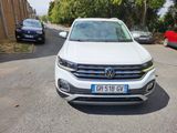 the white volkswagen suv is parked on the side of the road